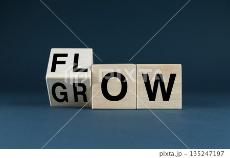 Wooden blocks spell out the words FLOW and GROW Wooden blocks spell out the words FLOW and GROW 135247197