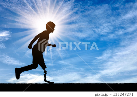 Silhouette of determined disabled boy runner with prosthetic leg 135247271