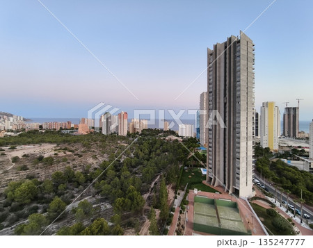 peaceful twilight view of seaside homes, calm and peaceful sunset over quiet residential area by sea 135247777