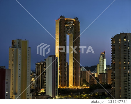 gleaming twilight skyscraper, goldenhighlighted skyscraper with reflective glass and dramatic lines 135247784