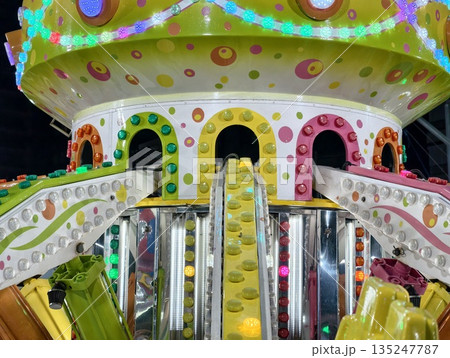 colorful carnival spectacle, vivid carnival attraction featuring glowing lights and lively 135247787