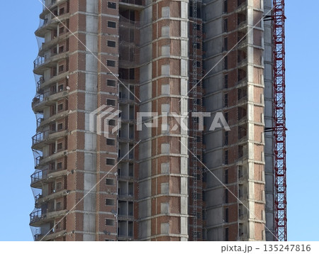 building site overview, residential building under construction with exposed slabs and facade building site overview, residential building under construction with exposed slabs and facade 135247816