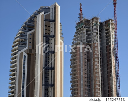 active construction of twin towers, overview of construction site with twin towers being built 135247818