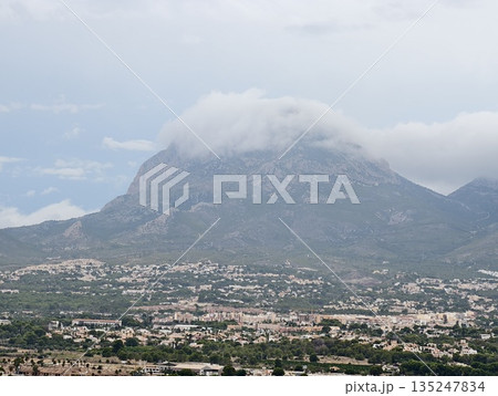 tranquil town nestled beneath mountain peaks, peaceful valley town surrounded by rolling hills tranquil town nestled beneath mountain peaks, peaceful valley town surrounded by rolling hills 135247834
