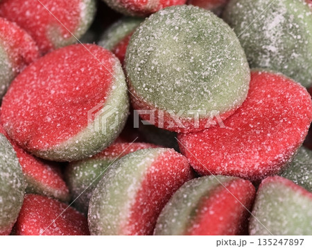 detailed macro image capturing lively red and green gummy discs coated in crystallized sugar detailed macro image capturing lively red and green gummy discs coated in crystallized sugar 135247897