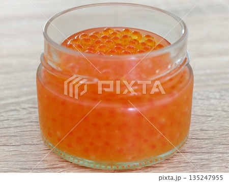 Highresolution image focusing on spherical salmon eggs and glass 135247955