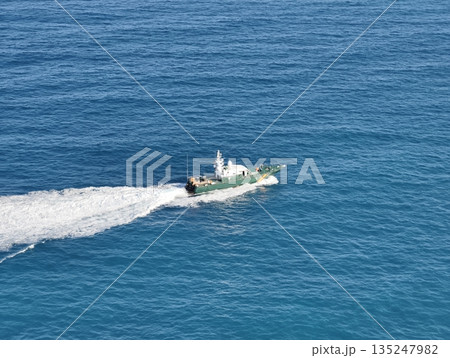 Highspeed patrol craft navigating azure waters with crew onboard Highspeed patrol craft navigating azure waters with crew onboard 135247982