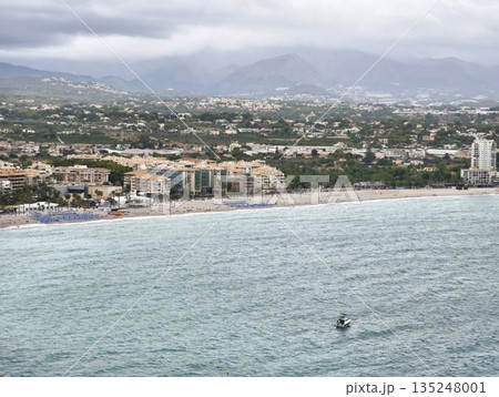 Peaceful coastal scene, Calm waters with distant mountains Peaceful coastal scene, Calm waters with distant mountains 135248001