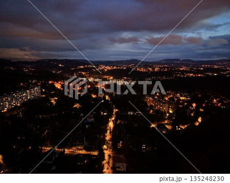 Nighttime Cityscape With Glowing Streets, Drone View Showcasing Illuminated Streets And Scenic City Backdrop Nighttime Cityscape With Glowing Streets, Drone View Showcasing Illuminated Streets And Scenic City Backdrop 135248230
