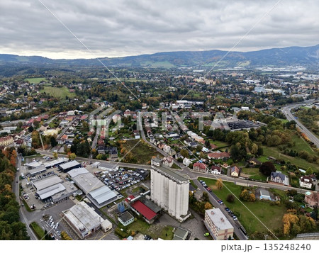 Urban Tower Amidst Shops And Hills, Commercial Structure Surrounded By Residential Areas And Nature 135248240