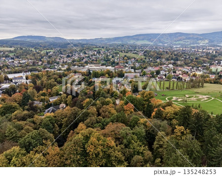Drone Footage Showcasing Autumnal Hues Blending With Neighborhood Patterns And Distant Urban Skyline Drone Footage Showcasing Autumnal Hues Blending With Neighborhood Patterns And Distant Urban Skyline 135248253
