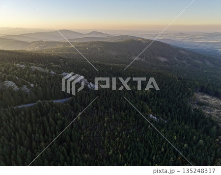 First Light Of Day Reveals Serene Mountain Ridge Wrapped In Gentle Fog And Distinct Contours 135248317