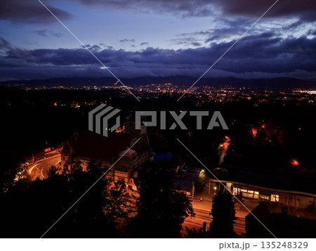 Village At Night, Charming Nocturnal Village With Amber Illumination Contrasting With Vast Night Sky Village At Night, Charming Nocturnal Village With Amber Illumination Contrasting With Vast Night Sky 135248329