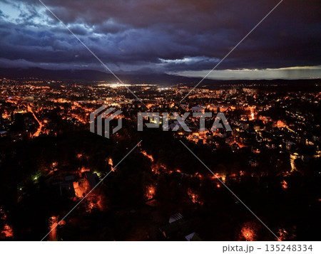 Urban Nightscape Imagery, Nighttime Urban Panorama Showcasing Glowing Streets And Distant Skyscrapers 135248334