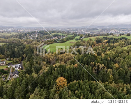 Colored Trees Amidst Quiet Neighborhood, Seasonal Transformation Depicted In Tranquil Leafy Townscape 135248338