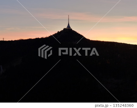 Modern Tower With Signal Themes, Cityscape Featuring Spire Silhouette And Glowing Horizon At Sunset Modern Tower With Signal Themes, Cityscape Featuring Spire Silhouette And Glowing Horizon At Sunset 135248360