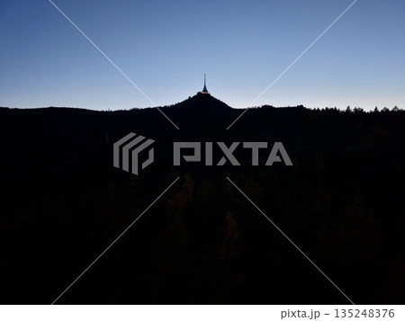 Twilight Mountain View, Silhouette Of Solitary Tower, Sunset Horizon With Shadowed Forests And Rugged Ridge Twilight Mountain View, Silhouette Of Solitary Tower, Sunset Horizon With Shadowed Forests And Rugged Ridge 135248376