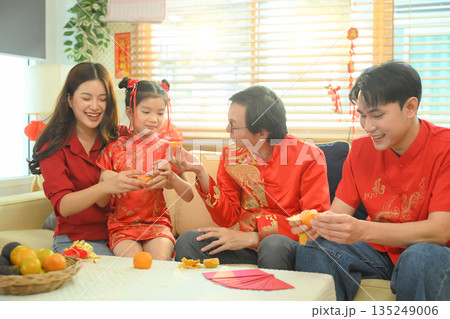 Asian grandparents giving red envelope to descendants during Chinese New Year family reunion Asian grandparents giving red envelope to descendants during Chinese New Year family reunion 135249006
