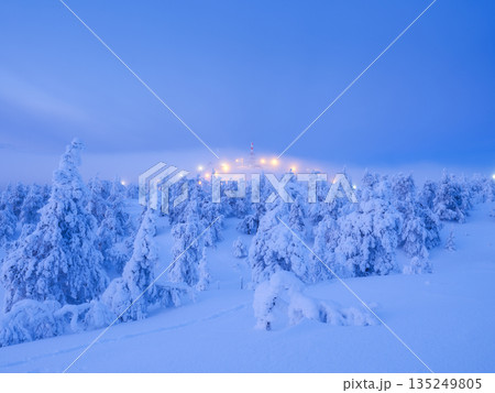 Serene cold atmosphere, majestic peaks, crystal reflections. Winter mountain landscape at blue hour. Serene cold atmosphere, majestic peaks, crystal reflections. Winter mountain landscape at blue hour. 135249805