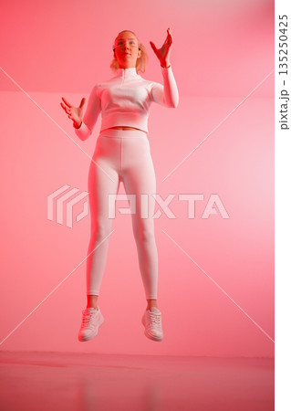 Woman in smartglasses gesturing in mid-air 135250425