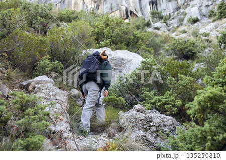 young pretty brunette girl hiking to waterfall, lifestyle people concept 135250810