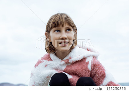 little cute blond girl curious smiling playing outside on sea, lifestyle people concept 135250836
