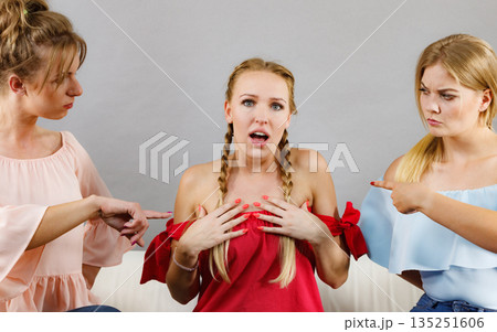 Woman being bullied by two females Woman being bullied by two females 135251606
