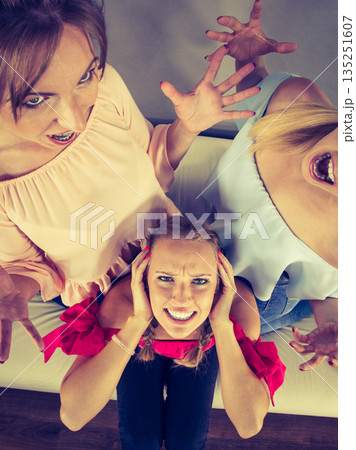 Woman being bullied by two females Woman being bullied by two females 135251607