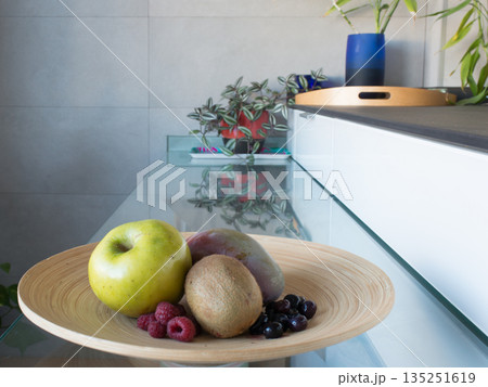 Fruiterer with fresh fruit: apple, mango, kiwi, rapberries and blueberries Fruiterer with fresh fruit: apple, mango, kiwi, rapberries and blueberries 135251619
