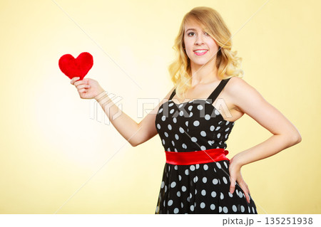 Woman holding red heart love symbol Woman holding red heart love symbol 135251938