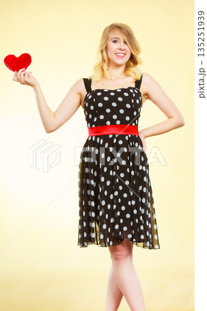 Woman holding red heart love symbol Woman holding red heart love symbol 135251939