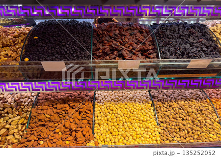 Close view of glazed nuts separated by glass dividers in a confectionery counter in Istanbul bazaar. Texture emphasis, color contrast, indulgent choice, and tactile appeal within premium snack Close view of glazed nuts separated by glass dividers in a confectionery counter in Istanbul bazaar. Texture emphasis, color contrast, indulgent choice, and tactile appeal within premium snack 135252052
