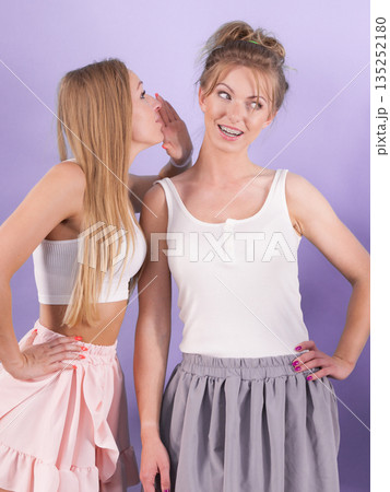 Two females gossiping having fun Two females gossiping having fun 135252180