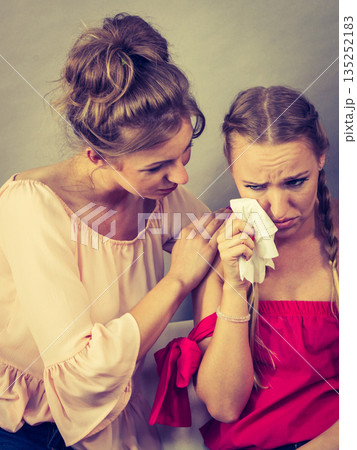 Friend comforting sad woman Friend comforting sad woman 135252183