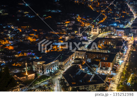 Night cityscape with residential buildings, illuminated center streets, and historic churches and mosques, view from above, Berat, Albania 135252398