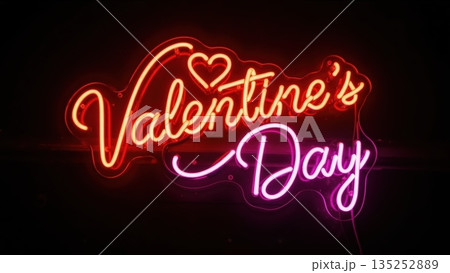 Glowing Valentine's Day neon sign. Romantic red and pink illuminated lettering with a heart on a black background. Holiday love concept 135252889