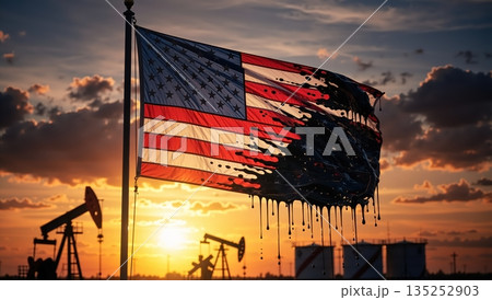 An American flag covered in dripping crude oil at an oil field during sunset. A conceptual image symbolizing fossil fuel dependency, the USA energy industry, and environmental pollution 135252903