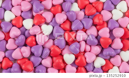 Background of colorful heart shaped candies. Sweet pink red and purple sugar hearts texture. Valentine's Day love concept Background of colorful heart shaped candies. Sweet pink red and purple sugar hearts texture. Valentine's Day love concept 135252910