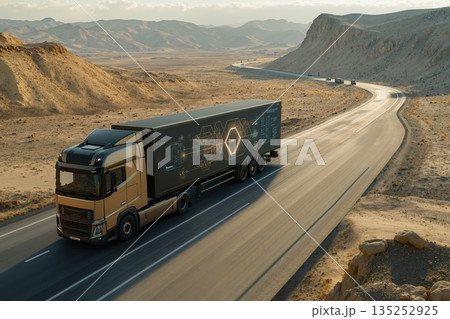 Futuristic semi-truck with a high-tech graphic on the trailer driving on a desert highway. Advanced logistics and the future of transportation concept Futuristic semi-truck with a high-tech graphic on the trailer driving on a desert highway. Advanced logistics and the future of transportation concept 135252925