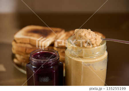 Creamy Peanut Butter Spread With Toasts And Jam On Kitchen Counter Creamy Peanut Butter Spread With Toasts And Jam On Kitchen Counter 135255199