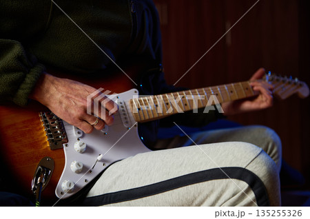 Person Playing Electric Guitar Close Up With Focused Hands On Neck Person Playing Electric Guitar Close Up With Focused Hands On Neck 135255326