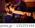 Young Guitarist Plays Electric Guitar In Warm Indoor Setting, Focusing On The Fretboard 135255348