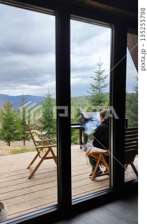 Man grilling food on a wooden terrace Man grilling food on a wooden terrace 135255798