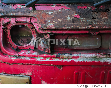 Rusty Red Truck Front with Missing Headlight and Corrosion, offering natural light and ample copy space for automotive restoration themes Rusty Red Truck Front with Missing Headlight and Corrosion, offering natural light and ample copy space for automotive restoration themes 135257819