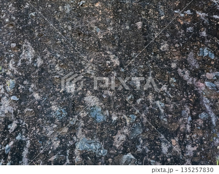 Abstract grunge texture with visible stones creating a rough natural pattern with ample copy space for graphic design and backgrounds Abstract grunge texture with visible stones creating a rough natural pattern with ample copy space for graphic design and backgrounds 135257830