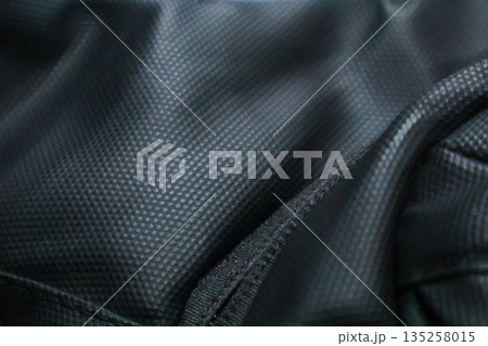 Detailed black nylon fabric texture background for fashion and industrial design, providing a durable and resilient textile option, perfect for sportswear and luggage 135258015