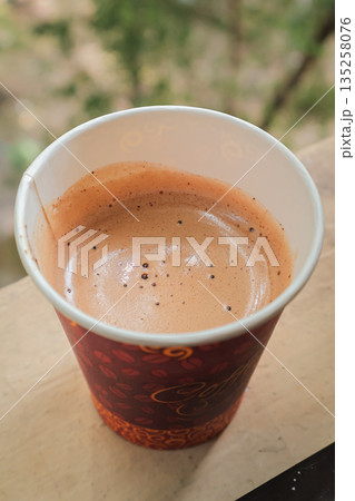 Fresh Espresso in Paper Cup, Natural Light: Enjoying a rich and aromatic espresso in a paper cup on a wooden surface, captured under soft natural light, perfect for coffee break Fresh Espresso in Paper Cup, Natural Light: Enjoying a rich and aromatic espresso in a paper cup on a wooden surface, captured under soft natural light, perfect for coffee break 135258076