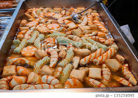 Assorted Fish Cake Soaking in Broth with Natural Light in Metal Tray, street food offering a variety of textures and flavors Assorted Fish Cake Soaking in Broth with Natural Light in Metal Tray, street food offering a variety of textures and flavors 135258095