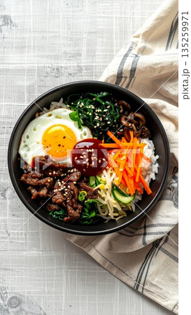 Studio Food Photography of Korean Bibimbap in Black Ceramic Bowl Studio Food Photography of Korean Bibimbap in Black Ceramic Bowl 135259971