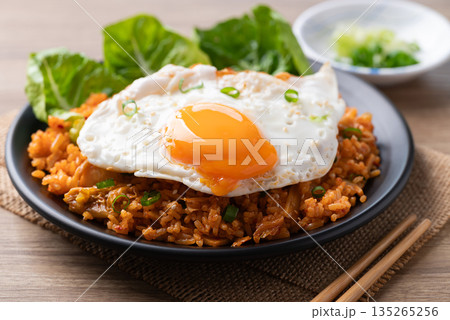 Korean kimchi fried rice with fried egg and spring onion on top Korean kimchi fried rice with fried egg and spring onion on top 135265256